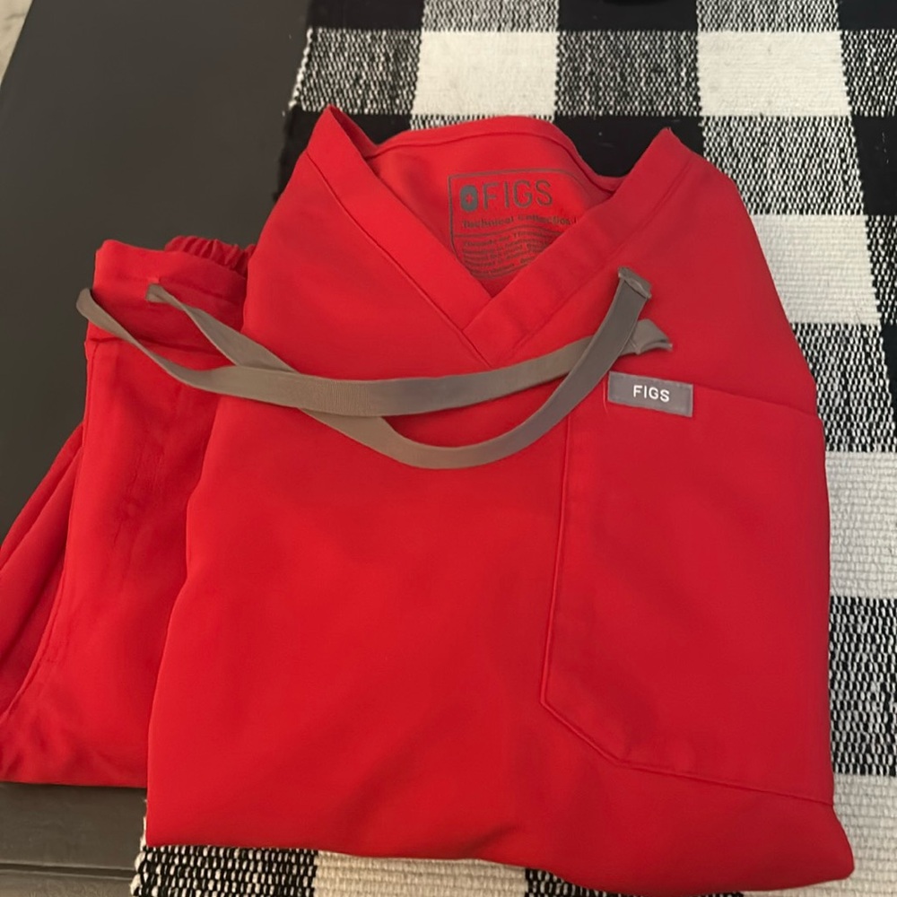Red figs scrubs. Pants are straight legged. Both top and bottoms are xxs.